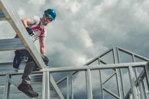 Men Wearing Safety Hard Hat and Harness. Residential Building Skeleton Steel Framing Contractor Worker.